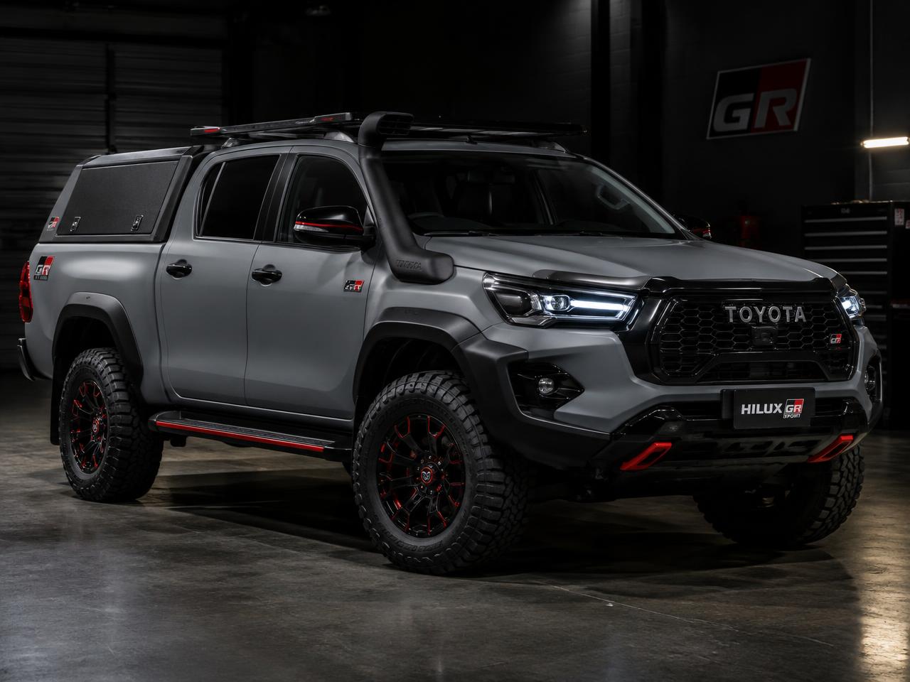 Custom satin grey Toyota Hilux with black-out body kit and snorkel